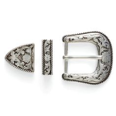 a pair of silver buckles with floral designs on the front and back, both in different sizes