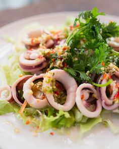 a white plate topped with an octopus salad