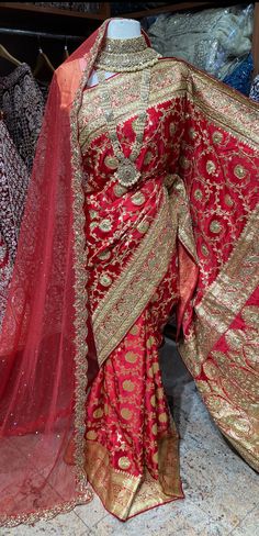 Bright red pink banarasi saree brilliantly crafted motifs in woven, stone and zardosi with zari weaved border and pallu around the drape captivates one towards it.  The saree has an unstitched blouse and a net dupatta perfect edit to your wedding rituals. Beautifully teamed with traditional pearl bridal jewelry set is Luxury Saree With Dabka Work For Traditional Ceremonies, Luxury Red Handwork Saree, Luxury Red Traditional Wear With Zari Weaving, Luxury Red Dupatta For Ceremonial Occasions, Luxury Wedding Saree With Meenakari, Luxury Festive Dupatta For Marriage, Luxury Red Pre-draped Saree For Traditional Ceremonies, Luxury Traditional Wedding Dress With Zari Work, Luxury Red Bollywood Style Saree