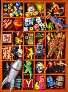 an orange wooden box filled with lots of toy figurines