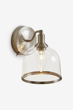 a light fixture with a glass dome on the side and a metal wall mounted light