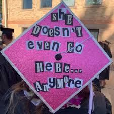 a pink graduation cap that says she doesn't even go here anymore