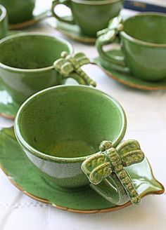 green cups and saucers with dragonflies on them