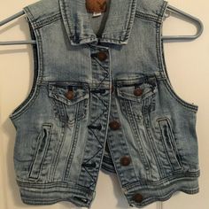 Light Wash, Never Worn American Eagle Denim Vest Trendy Cotton Denim Vest With Snap Buttons, Medium Wash Casual Denim Vest With Buttons, Casual Medium Wash Denim Vest With Buttons, Casual Dark Wash Denim Vest With Buttons, Trendy Dark Wash Denim Vest With Snap Buttons, Casual Cotton Denim Vest With Snap Buttons, Casual Cotton Denim Vest With Buttons, Casual Denim Vest With Snap Buttons For Spring, Spring Casual Denim Vest With Snap Buttons