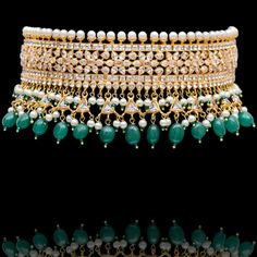 This regal set befitting a queen's closet, pays tribute to Mughal royalty and is the classiest way to embrace the festive season! A charmingly curated set, intricately detailed with the rich emerald drops and garnished with lush CZ and faux pearl beads. Approximate earrings length is. This set is available in 3 options: Necklace + Earrings Necklace + Earrings + Teekah Necklace + Earrings + Teekah + Jhoomar Please select the desired option at the time of purchase. Gold-plated on high-quality brass as the base metal. Made by order. Kindly allow 7-8 weeks for the delivery of this item. For custom or urgent requests, please contact support@alacouture.com. *Please Note: We use faux stones and beads in all of our jewelry. Traditional Emerald Necklace With Intricate Design For Formal Occasions, Elegant Hand Set Emerald Necklace For Reception, Elegant Hand-set Emerald Necklace For Reception, Traditional Formal Emerald Necklace, Luxury Stone Work Jewelry Sets For Festive Occasion, Elegant Emerald Kundan Necklace For Gift, Elegant Ceremonial Emerald Necklace With 17 Jewels, Elegant Jeweled Bridal Necklace For Ceremonial Occasion, Elegant Bridal Emerald Necklace With Intricate Design