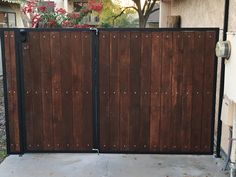 the gate is made of wood and has rivets on it's sides