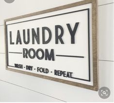 the laundry room sign is hanging on the wall