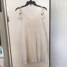 Never Worn! Has A Few Tiny Brown Spots But It Came Like That Summer V-neck Mini Dress With Tassels, Summer Dresses With Tassels For Day Out, Casual White Tassel Dress, Casual White Dress With Tassel Ties, Casual White Dress With Tassels, Casual White Dresses With Tassel Ties, Spring Day Out Dress With Tassels, Spring V-neck Mini Dress With Tassels, White Fringe V-neck Dress