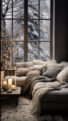 a living room filled with lots of furniture next to a large window covered in snow