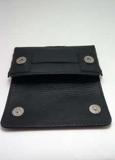 "This original case from our handmade black cowhide (italian genuine leather 100% ) and black thread offers great protection for your new best friend - Iphone 12 Pro max with a Magsafe from Apple protective cover on it. leather wallet to fit Iphone 12 Pro max with a Magsafe from Apple protective cover on it with size 164mm/83mm/10.5mm Natural black leather ( cow hide) black thread. metal rivets. two magnetic snaps closure belt loop- fit max 5cm or 2\" belt two card slots Wallet has a hole below, Black Trifold Wallet With Snap Closure, Classic Leather Card Holder With Snap Closure, Black Rectangular Trifold Wallet With Snap Closure, Black Rectangular Wallet With Snap Closure, Leather Wallet With Snap Closure, Rectangular Leather Wallet With Snap Closure, Snap Closure Rectangular Leather Wallet, Leather Bifold Card Holder With Snap Closure, Cowhide Wallet