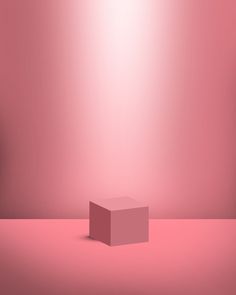 a pink box sitting on top of a table in front of a red wall and floor