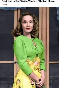 a woman in a green top and yellow dress posing for the camera with her hand on her hip