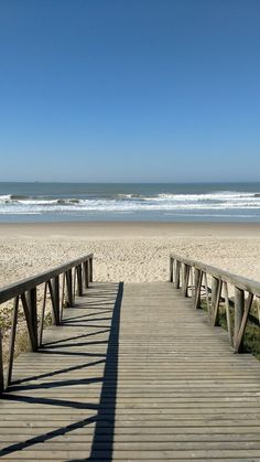 a wooden walkway leading to the beach