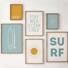 four framed pictures on the wall with surf sayings in different colors and sizes, including one that says stay wild ocean child