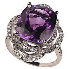 Delightful cocktail ring of cushion cut Amethyst, 7.63ct, in 14K white gold setting featuring 0.61ct of Diamonds. The two looping halos of Diamonds create an elegant and dramatic setting for this lovely Amethyst. The diamonds continue down the top of the shank of the ring. No changes by seller. This is a sizable 6.5 which your local jeweler can assist you with if you should need to size. MR2350 Elegant Amethyst Diamond Ring With Gemstone Accents, Elegant Amethyst Rings With Gemstone Accents, Luxury White Gold Amethyst Ring With Diamond Accents, Formal Purple Sapphire Ring With Gemstone Accents, Exquisite Amethyst Wedding Ring With Gemstone Accents, Luxury Purple Gemstones With Halo Setting, Elegant Ring With Amethyst Center Stone, Elegant Evening Rings With Center Stone, Elegant Purple Diamond Ring With Gemstone Accents