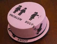 a pink cake with black writing on it and an image of two people holding hands