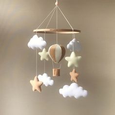 a mobile with stars, hot air balloon and clouds