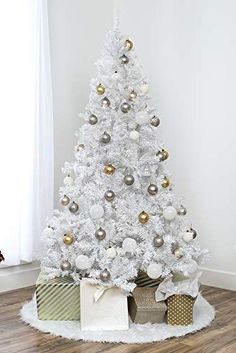 a white christmas tree with gold and silver ornaments