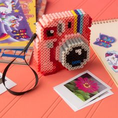 a camera made out of beads sitting on top of a table