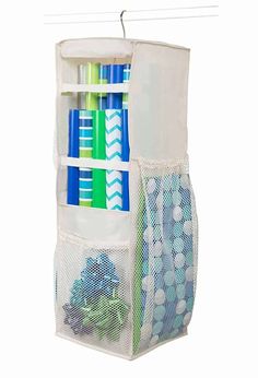 a white hanging organizer with blue and green items in it