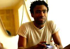 a man sitting at a table holding a game controller