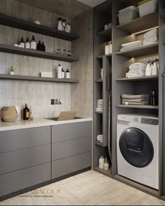 a washer sitting inside of a kitchen next to a dryer and shelves filled with dishes