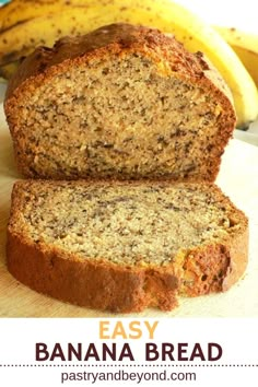 a loaf of banana bread sitting on top of a cutting board next to some bananas