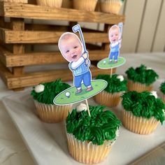 some cupcakes with green frosting on top of them