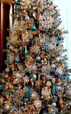 a decorated christmas tree with blue and silver ornaments