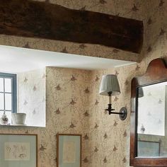 an old fashioned bathroom with wallpaper and mirror