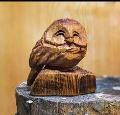 a carved owl sitting on top of a tree stump