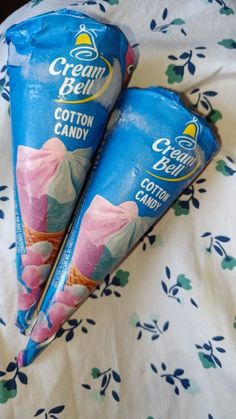 two candy cones sitting on top of a bed