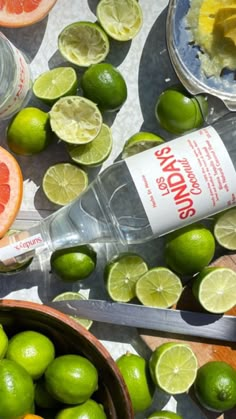 limes, grapefruit and water are on the table