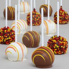 several chocolate covered candies with white and gold sprinkles on them are lined up in rows