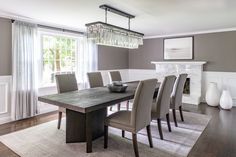 a dining room table with chairs and a chandelier