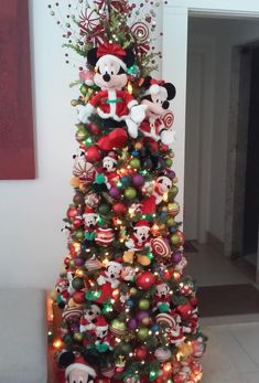 a christmas tree decorated with mickey mouse ornaments