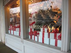 a store window with red and white wrapped presents