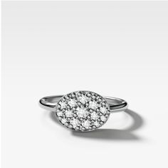 a white gold ring with diamonds on the top and bottom, set in 18k white gold