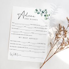 the wedding advice card is next to some dried flowers on a white tablecloth, which has been placed in front of it