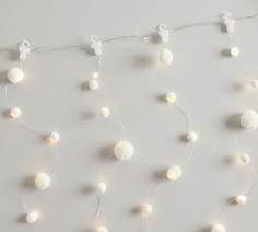 white balls and string lights strung from the ceiling