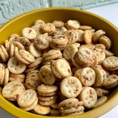 a yellow bowl filled with cookies on top of a table