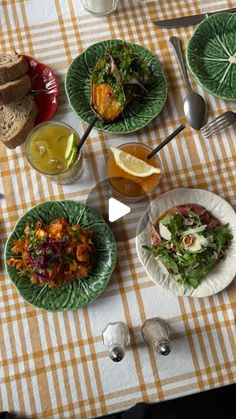 a table topped with plates and bowls filled with different types of food next to utensils