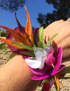 a close up of a person's arm wearing a bracelet with flowers on it