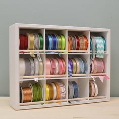 a shelf filled with lots of different colored ribbons