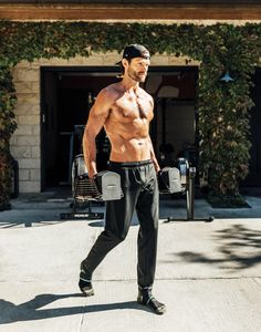 a shirtless man walking down the street