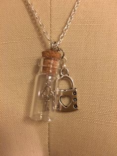 "Necklace with a key in a glass bottle with a lock Silver chain 19\" in length Glass Bottle 1.25\" in length" Lock And Key Necklace, Under Lock And Key, Astoria Ny, Key Necklace, Lock And Key, Glass Bottle, Make And Sell, Charm Necklaces, Glass Bottles