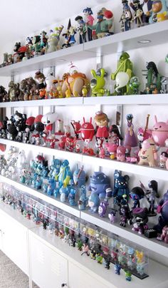 the shelves are filled with many different kinds of figurines