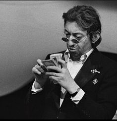 black and white photograph of man in suit playing cards