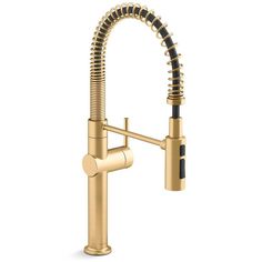 a kitchen faucet with a gold finish and black hose running from the side