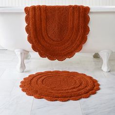 an orange rug is next to a white bathtub